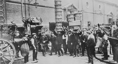 View of expert basket carriers and a group of market men, 1900 by English Photographer